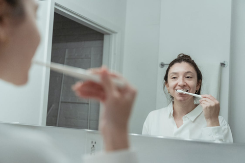 Mirror shot of a person brushing their teeth