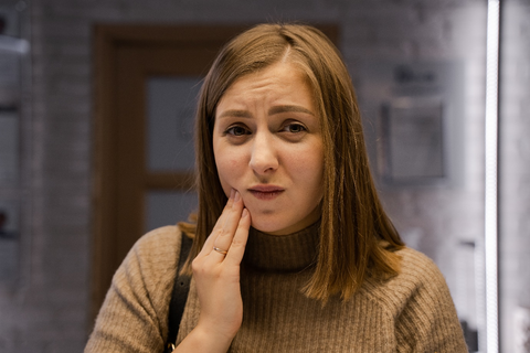 a woman with hand on her cheek