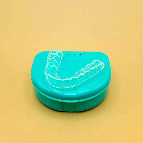 A custom dental guard placed on its case