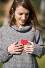 Arjun Chaal Powder for heart health (A Women holding a heart shaped paper cutout)