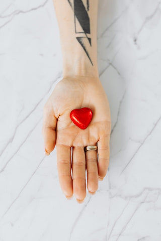 chyawanprash for heart health ( a woman holding a heart in hand)