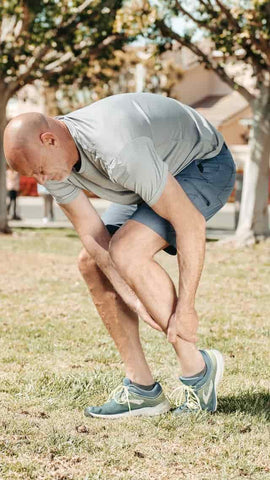 A man holding his ankle due to ankle pain - Amla Powder is great to treat joint pain