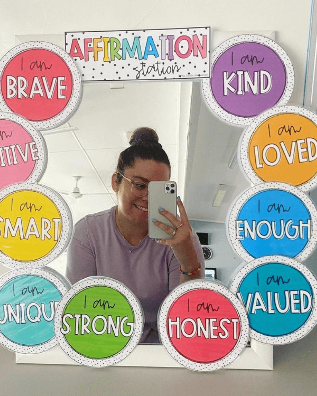Three images show the Spotty Brights Affirmation Stations around a tall, square and round mirror in three different classrooms. In the middle and right image, we see two smiling teachers taking a photo in the mirror.” style=