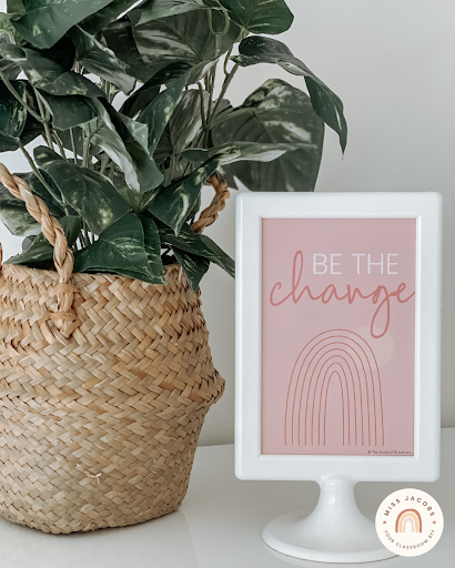 The left image shows a pot plant in a basket and a small pink sign that says ‘Be the change’ with an illustrated pink rainbow. The right image is a poster that says ‘When it rains look for rainbows’ with a mint green pen to the right.” style=