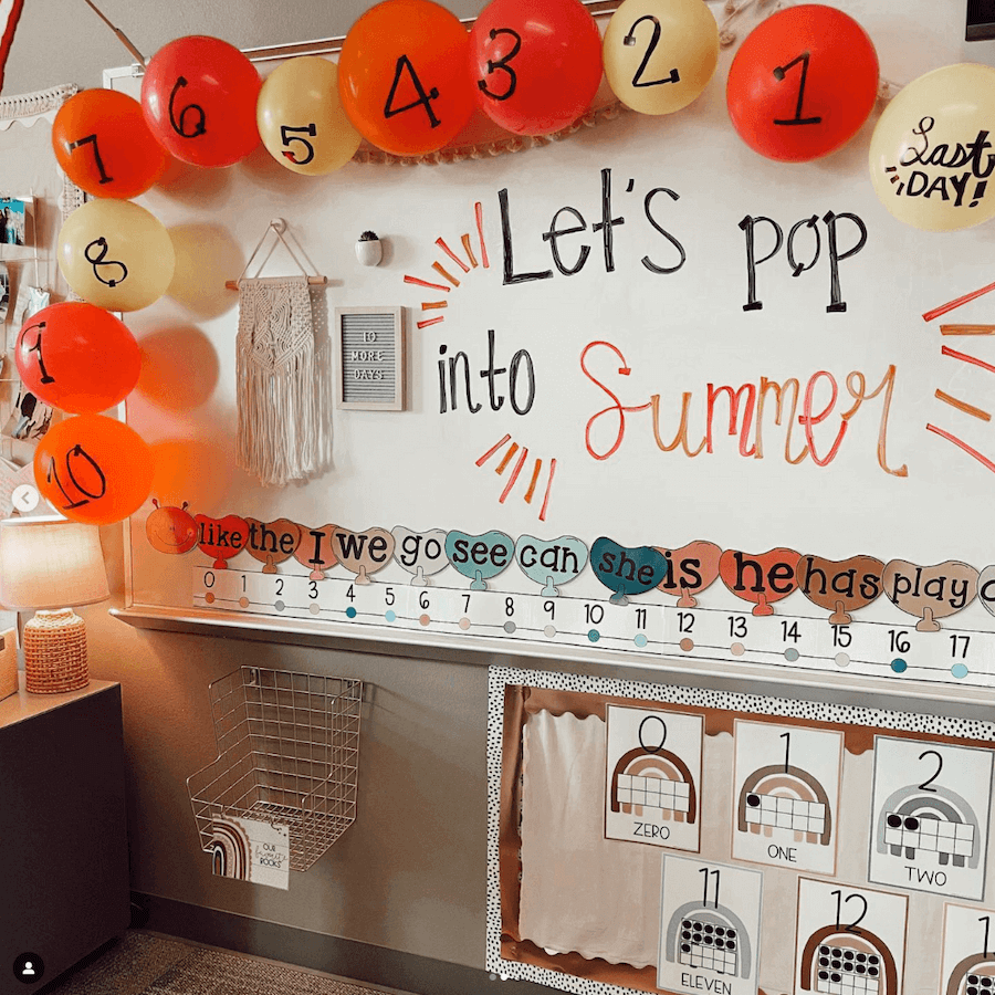 Two images show a classroom whiteboard that’s surrounded with red, orange and yellow balloons, they’re numbered 10-1, and one is labelled ‘last day.’ The words ‘Let’s pop into summer’ are written in cursive handwriting on the board. The teacher, Miss B, wears a yellow sundress and denim jacket.