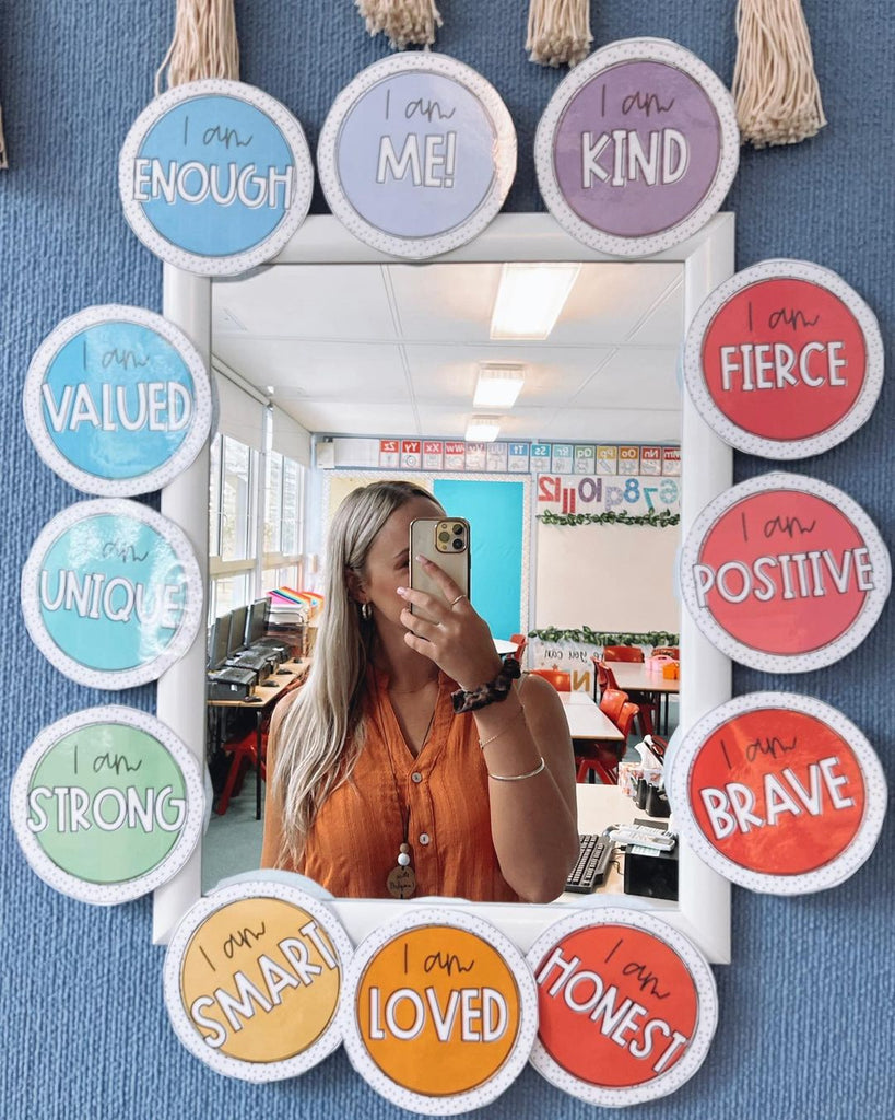 @learningwithmiss_campbell is taking a selfie in a white rectangle mirror, bordered by colourful affirmations from my Spotty Brights decor.