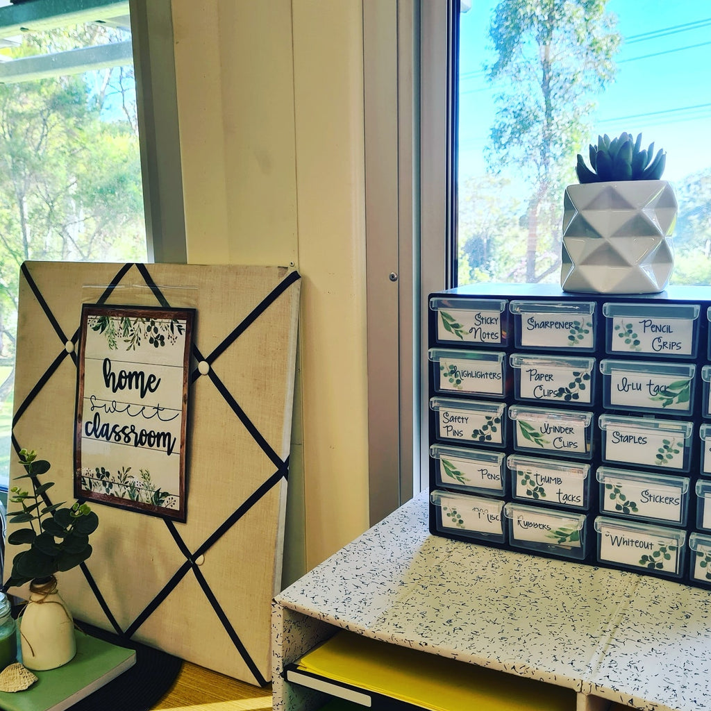 Two images show different applications of the Botanics Collection. On the left a trolley sits on top of a green rug with a leaf pattern. The draws are labelled with the words treats, pencils, stickers, prize box as well as the days of the week. On the right, a small teacher toolbox is labelled with small botanical labels and contains items like safety pins, thumb tacks, stickers and whiteout.