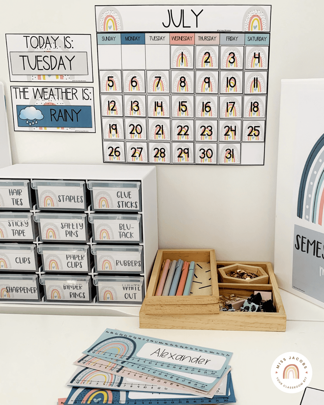 Two images show items from the Modern Rainbow range including a sign that says ‘First Day of School.’ We also see a calendar, a mini toolbox, name tags and some office supplies. The calming colour scheme includes soft blues, mustards, grays and pinks.