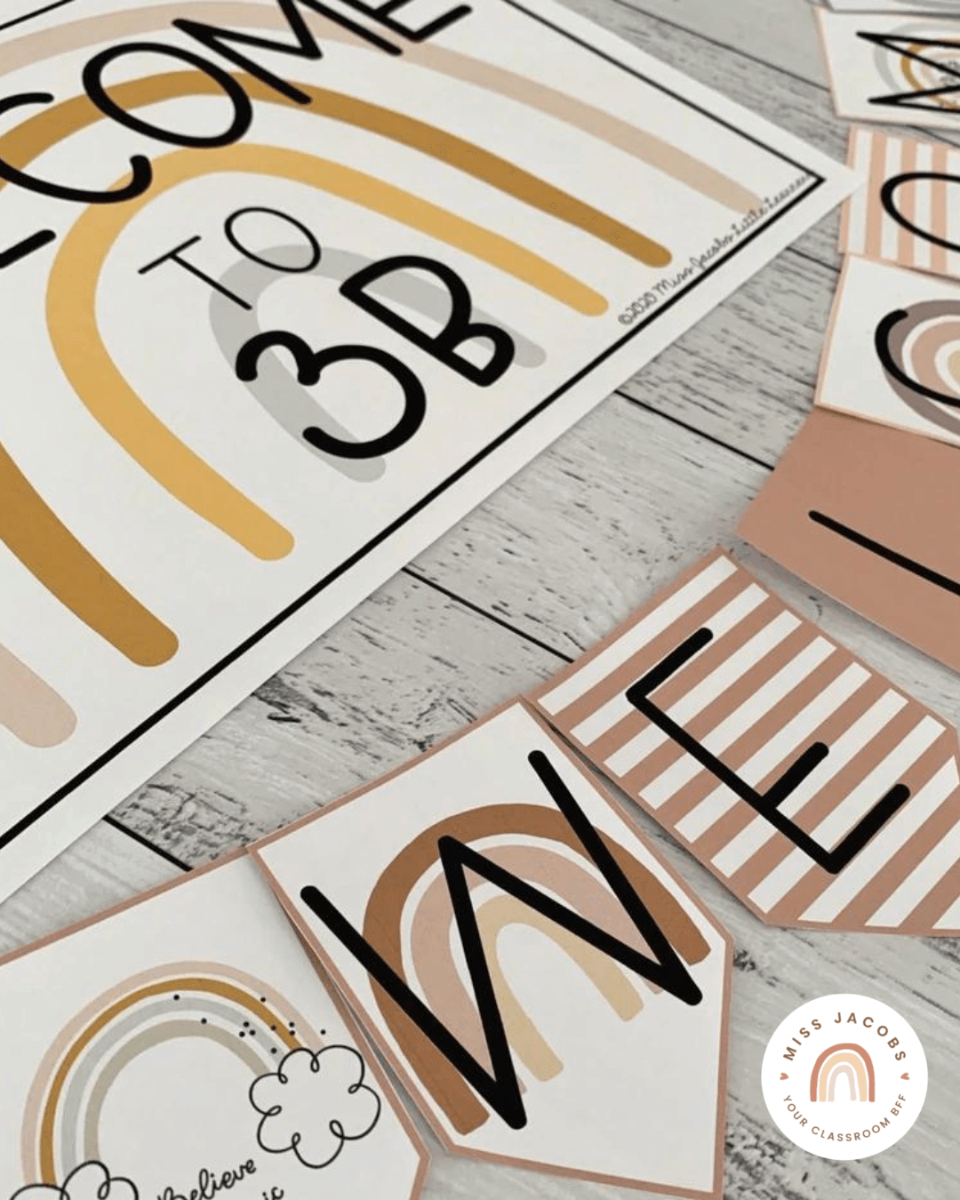 Two close up images show decor items from the Boho Rainbow range - there’s a ‘welcome to 3B’ sign and a sign saying ‘our birthdays.’ There’s also months with names listed underneath.” style=