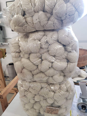 Yes sir, three bags full of Romney Millspun Yarn stacked on a table in the mill