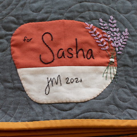 Hand embroidered quilt label