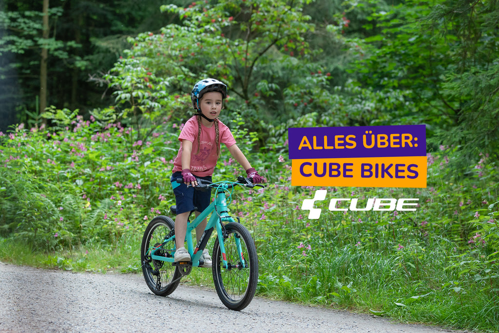 Junges Mädchen auf Cube Kinderfahrrad auf Schotterweg