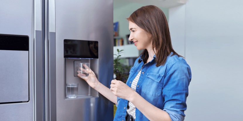 GF-The-woman-collects-water-from-the-refrigerator