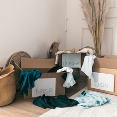 A room full of clutter sorted into 3 boxes namely Keep, Donate or Throw