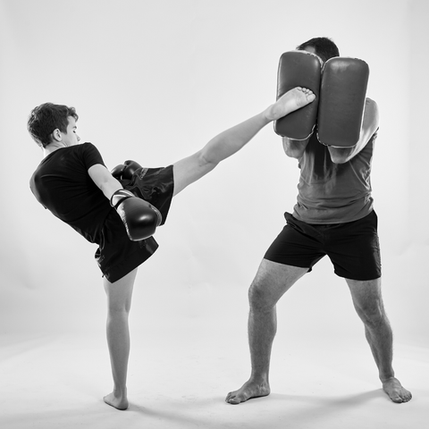 muay thai kid kicking pads