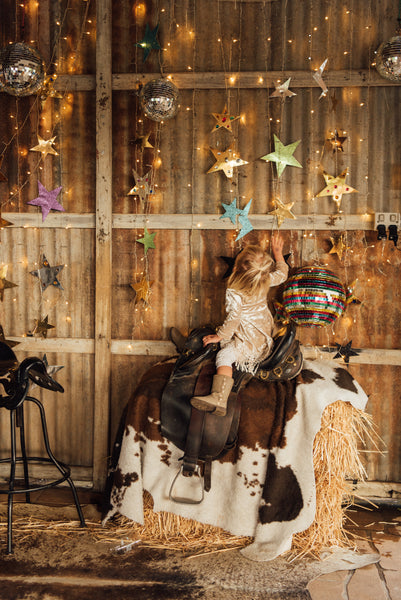 cowgirl, baby on bale of hay