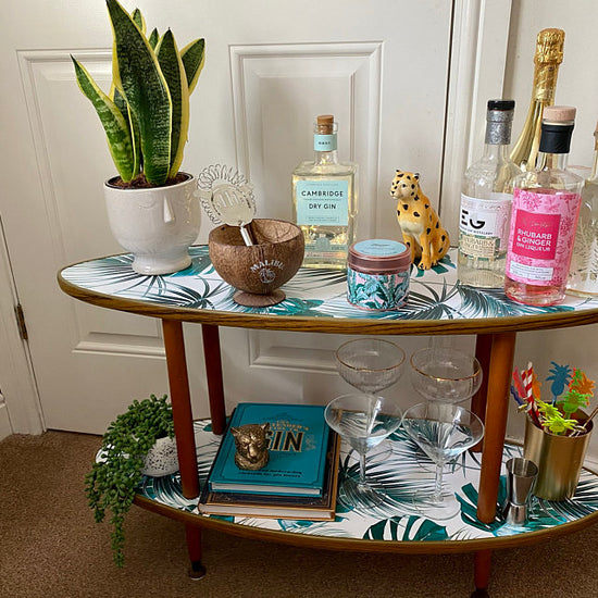 A coffee table covered with restowrap's Copacabana botanical tropical leaf design