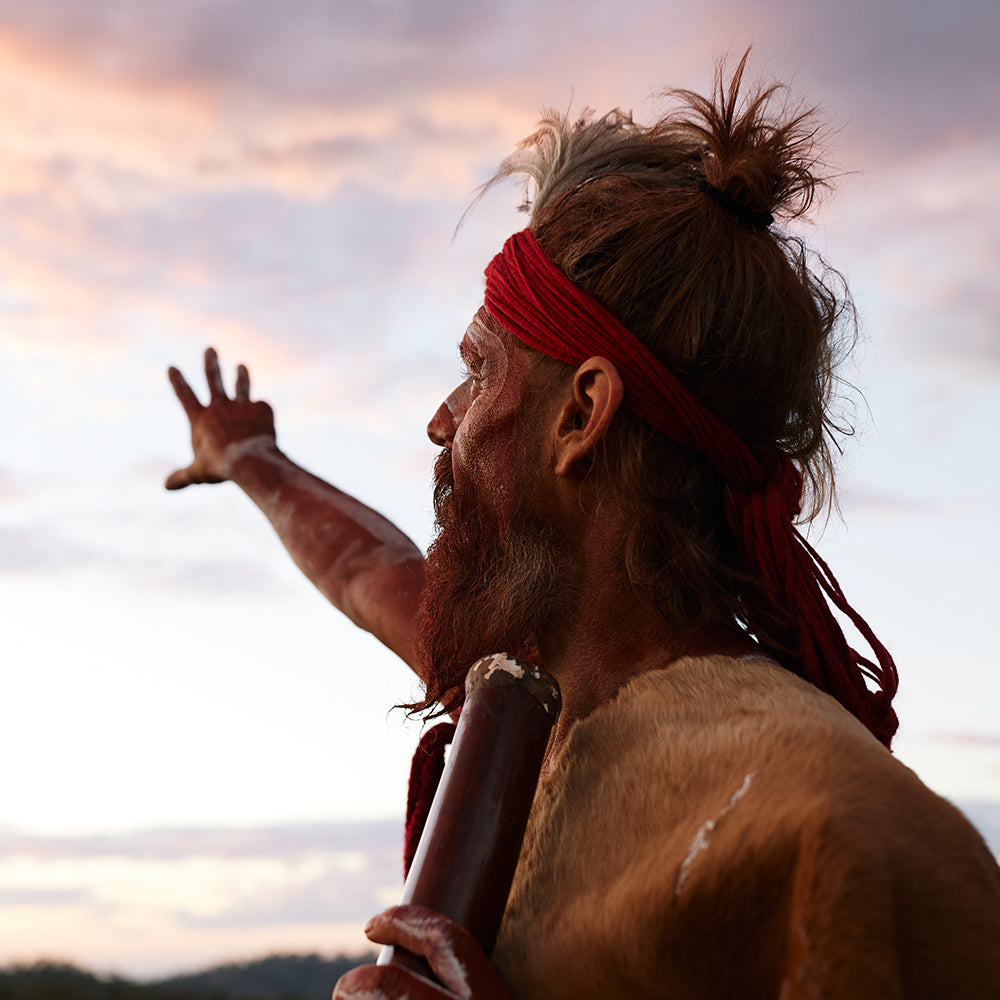 First Nations Man in traditional dress telling dreamtime story