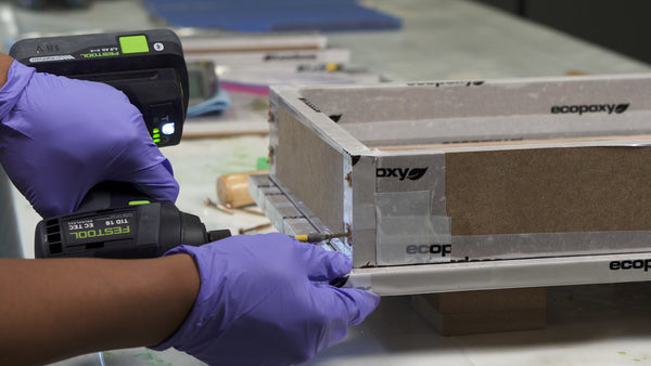 Drilling screws into casting mold for epoxy