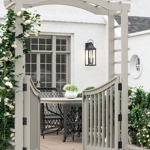 Garden gate with a shot of a small table and an exterior wall sconce