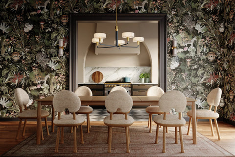 Chandelier hanging over a dining room table. Dark floral wallpaper is behind it