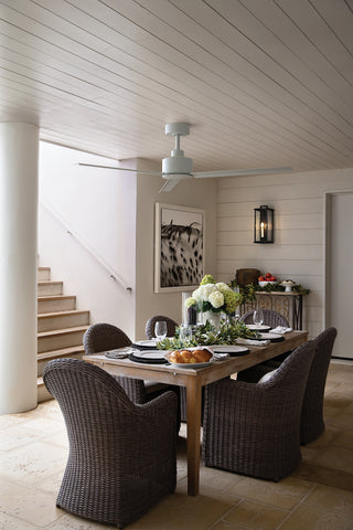 Outdoor white ceiling fan hanging over an outdoor table setting
