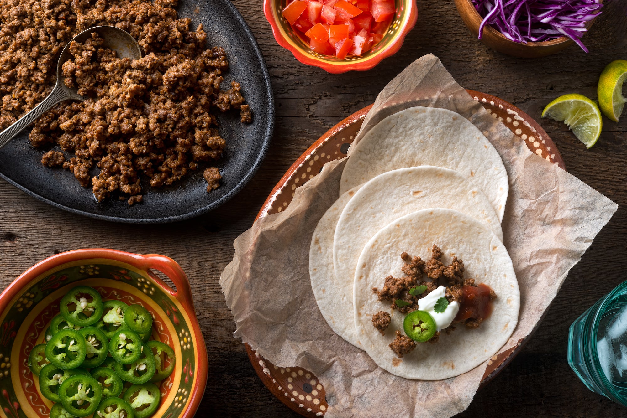 ground beef tacos with tomato lettuce and jalapeno 