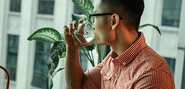 A man drinking a glass of water