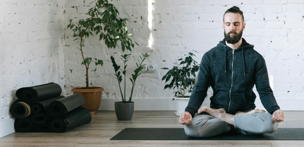 A man practicing yoga nidra in the morning