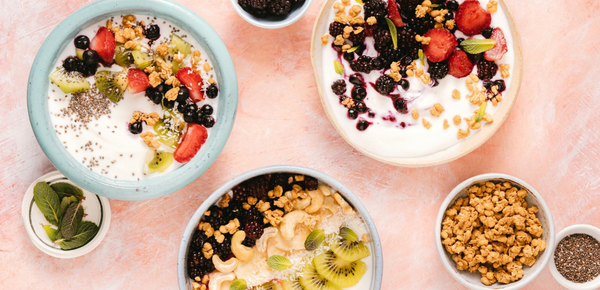 A nutritious breakfast of yoghurt, Mixed Fruits and Nuts in Ceramic Bowls