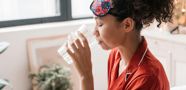 A woman drinking water in the morning