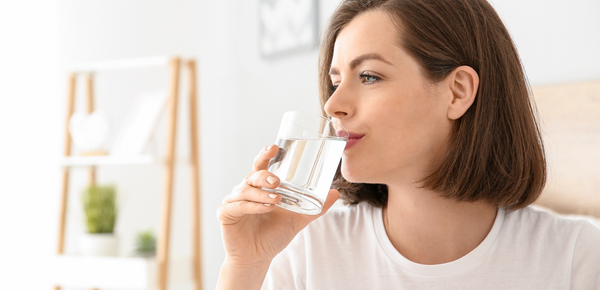 A women drinking a glass of fresh filtered water