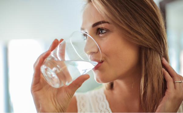 A woman enjoying a glass of fresh filtered water