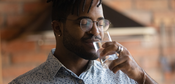 A man enjoying a glass of fresh filtered water
