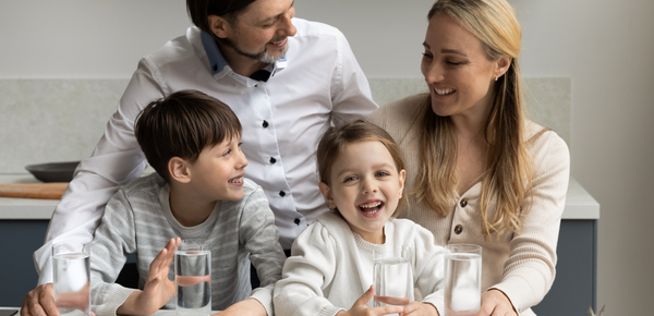 A happy family enjoying glasses of fresh filtered water