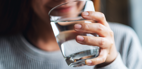 A woman enjoying a glass of filtered water