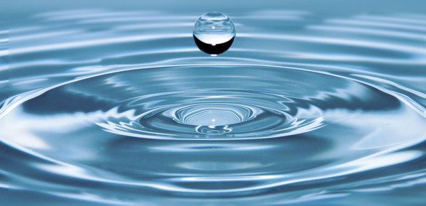 A water droplet and ripples in fresh filtered water