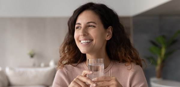 A woman enjoying a glass of filtered water