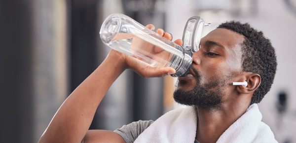 A man rehydrates with a bottle of fresh filtered water