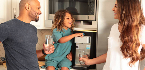 A family enjoys fresh filtered water from their Brio cooler