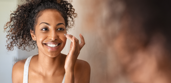 A women admires her smooth skin in the mirror
