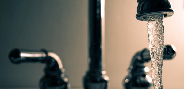 A close up of a running faucet