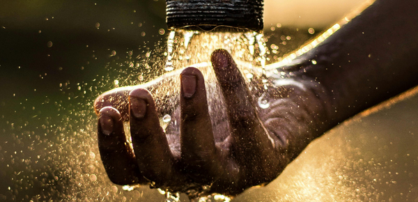 Water splashing onto a mans hand