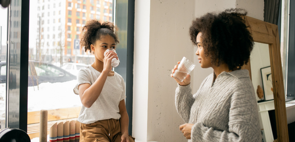 A mum and daughter drinking water