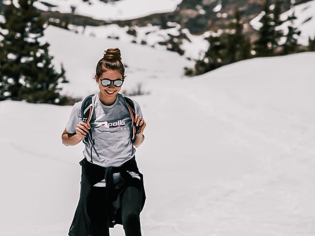 woman hiking in the snow wearing an Apollo Energy Gum shirt