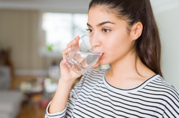 woman drinking a glass of water