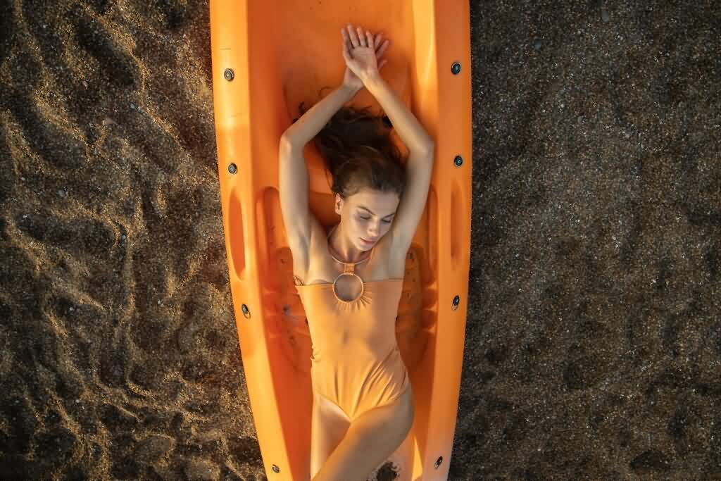 bikini laser hair removal woman lying on a boat 