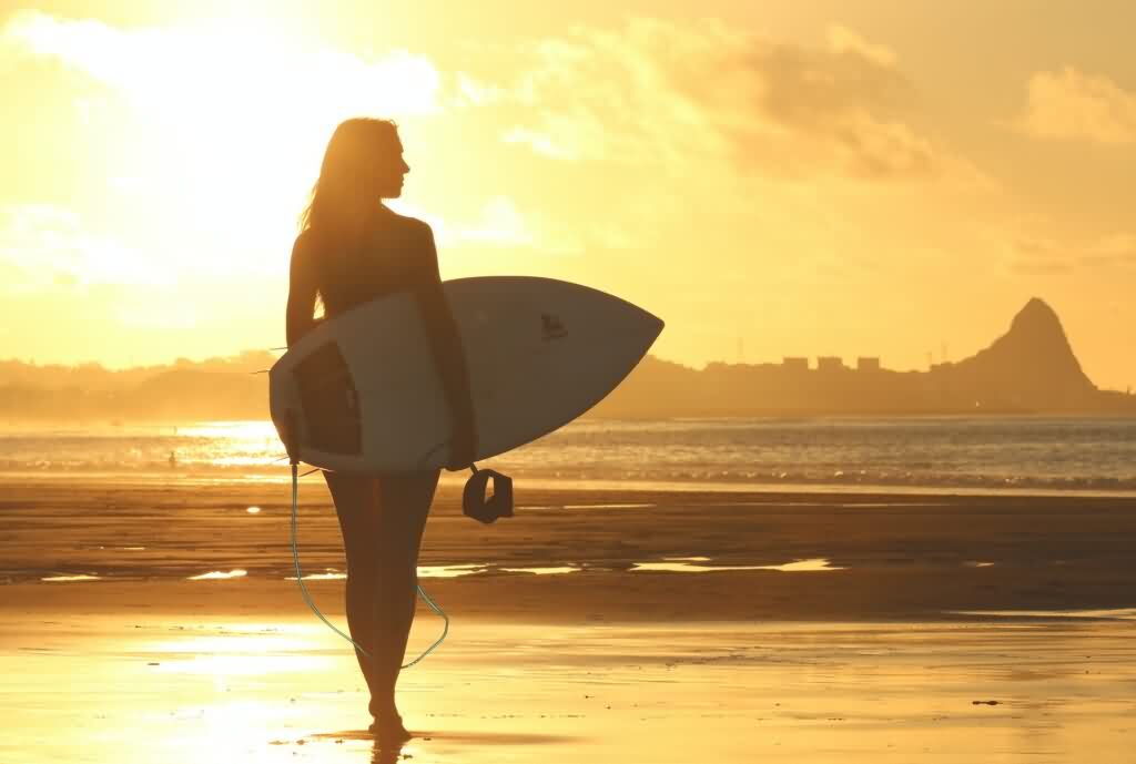 bikini laser hair removal woman holding surfboard