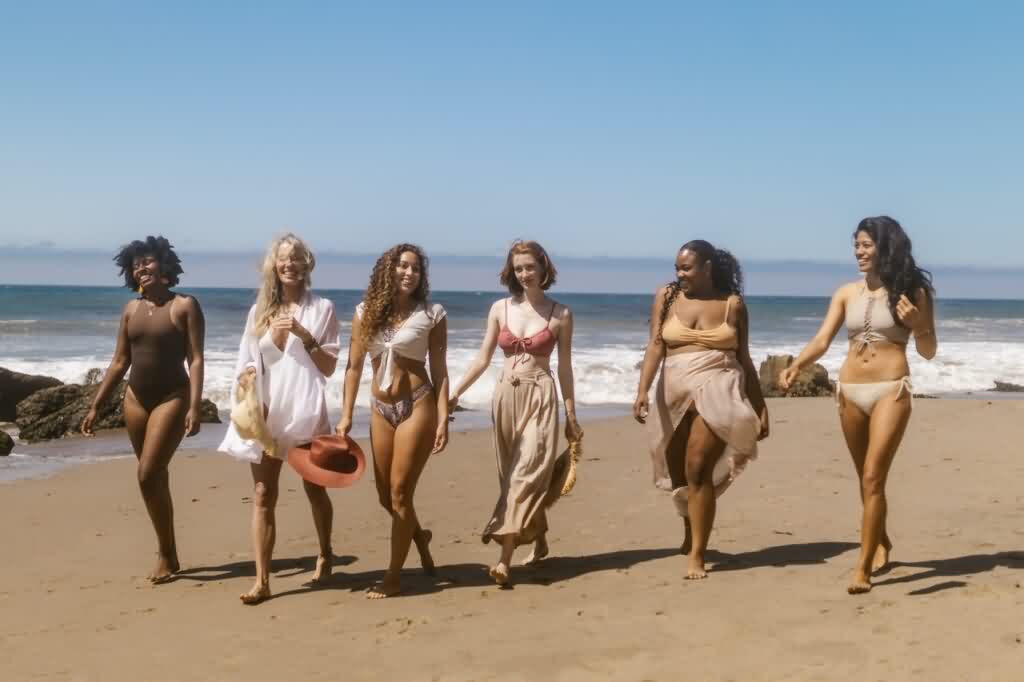 a group of laser hair removal models walking down the beach