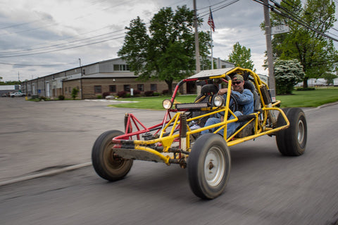 Picture of a yellow and red woods buggy with tree bars